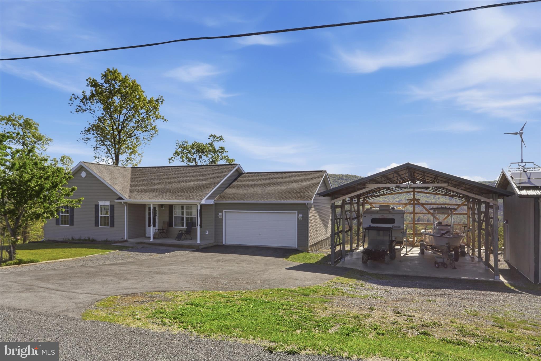 9580 Timber Ridge Road Big Cove Tannery, PA 17212 - Photo 6 of 56 a front view of a house with a yard and garage