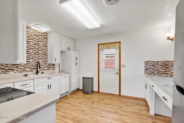 a kitchen with stainless steel appliances kitchen island granite countertop a refrigerator and a stove top oven