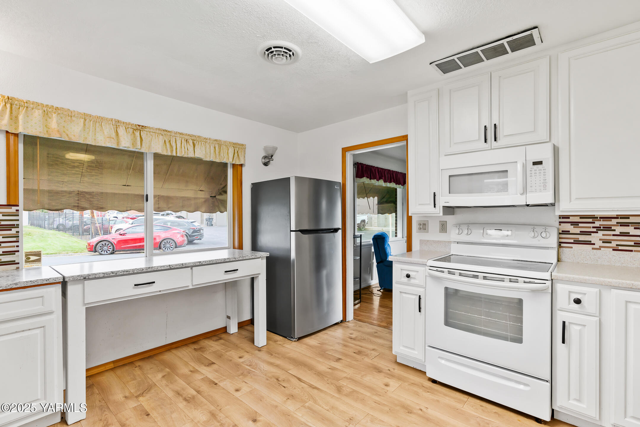 4101 Snowmountain Road Yakima, WA 98908 - Photo 8 of 15 a kitchen with a stove and white cabinets