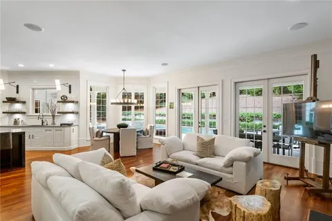 a kitchen with stainless steel appliances granite countertop a sink a stove and a window