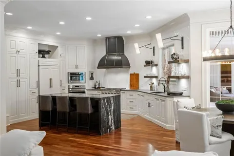 a kitchen with stainless steel appliances granite countertop a stove and a sink