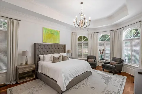 a bathroom with a double vanity sink a mirror and a bathtub