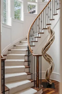 a bedroom with a bed painting on wall and a window