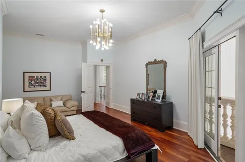 a kitchen with stainless steel appliances granite countertop a refrigerator a stove and a dining table with wooden floor