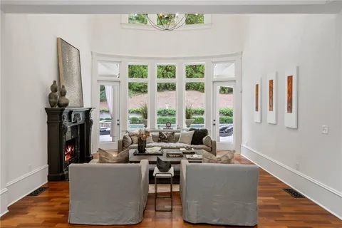 a living room with furniture and large windows
