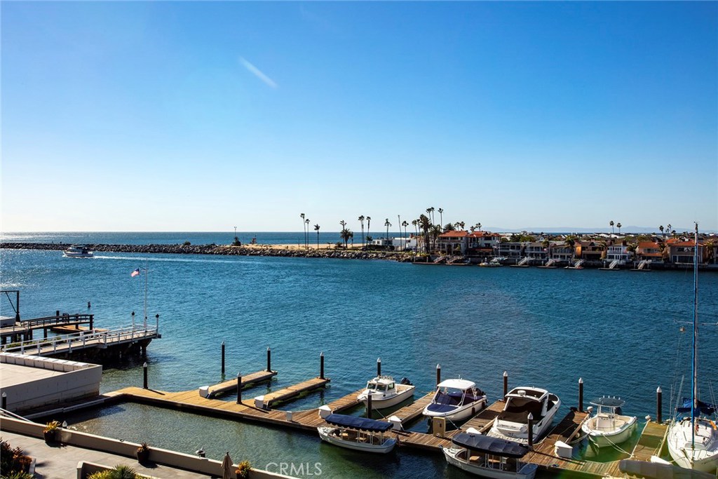 a view of a lake with lawn chairs