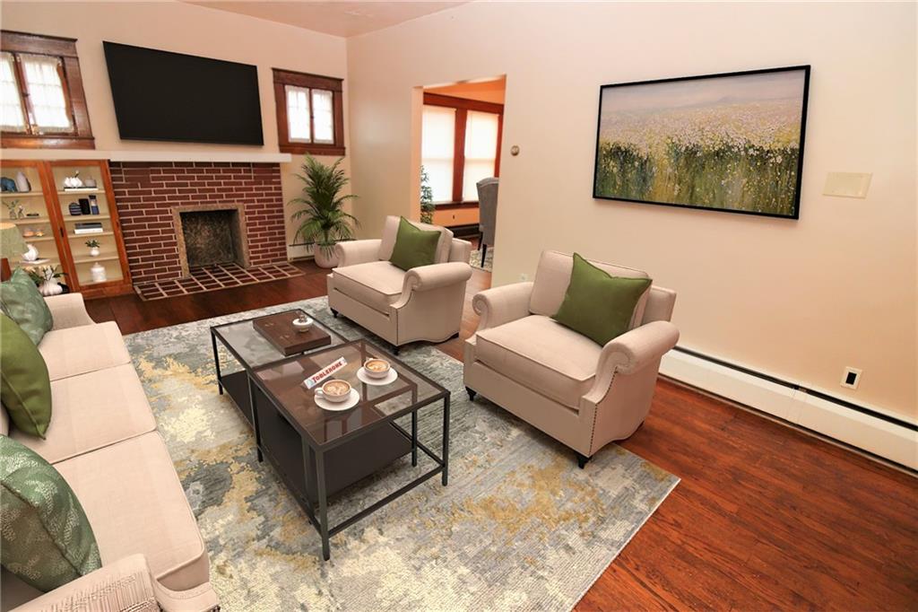 1443 State Avenue Coraopolis, PA 15108 - Photo 5 of 20 a living room with furniture a flat screen tv and a fireplace