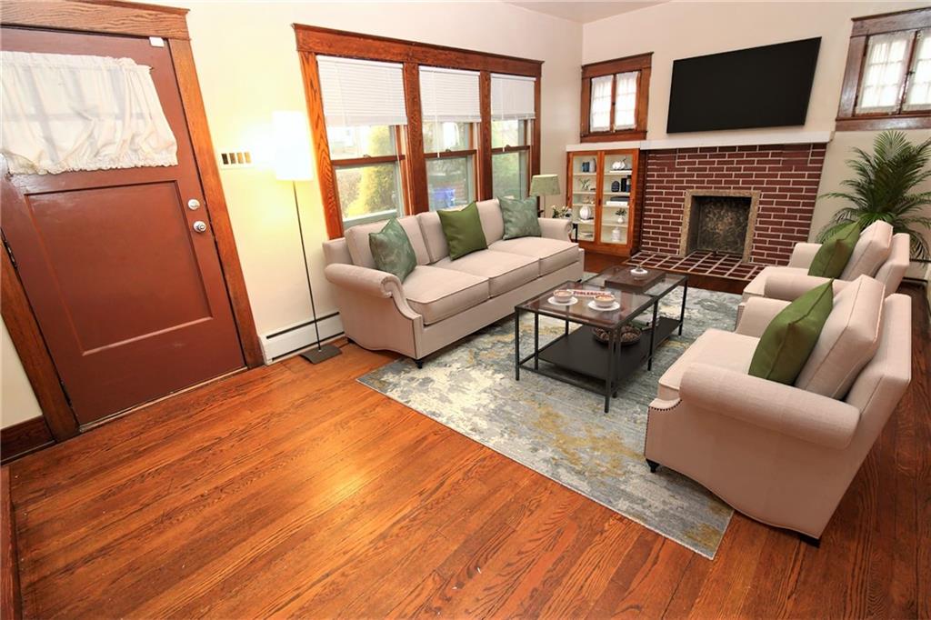 1443 State Avenue Coraopolis, PA 15108 - Photo 6 of 20 a living room with furniture a fireplace and a flat screen tv