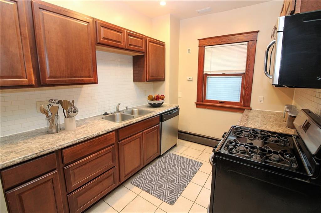 1443 State Avenue Coraopolis, PA 15108 - Photo 8 of 20 a kitchen with stainless steel appliances granite countertop a sink stove and refrigerator