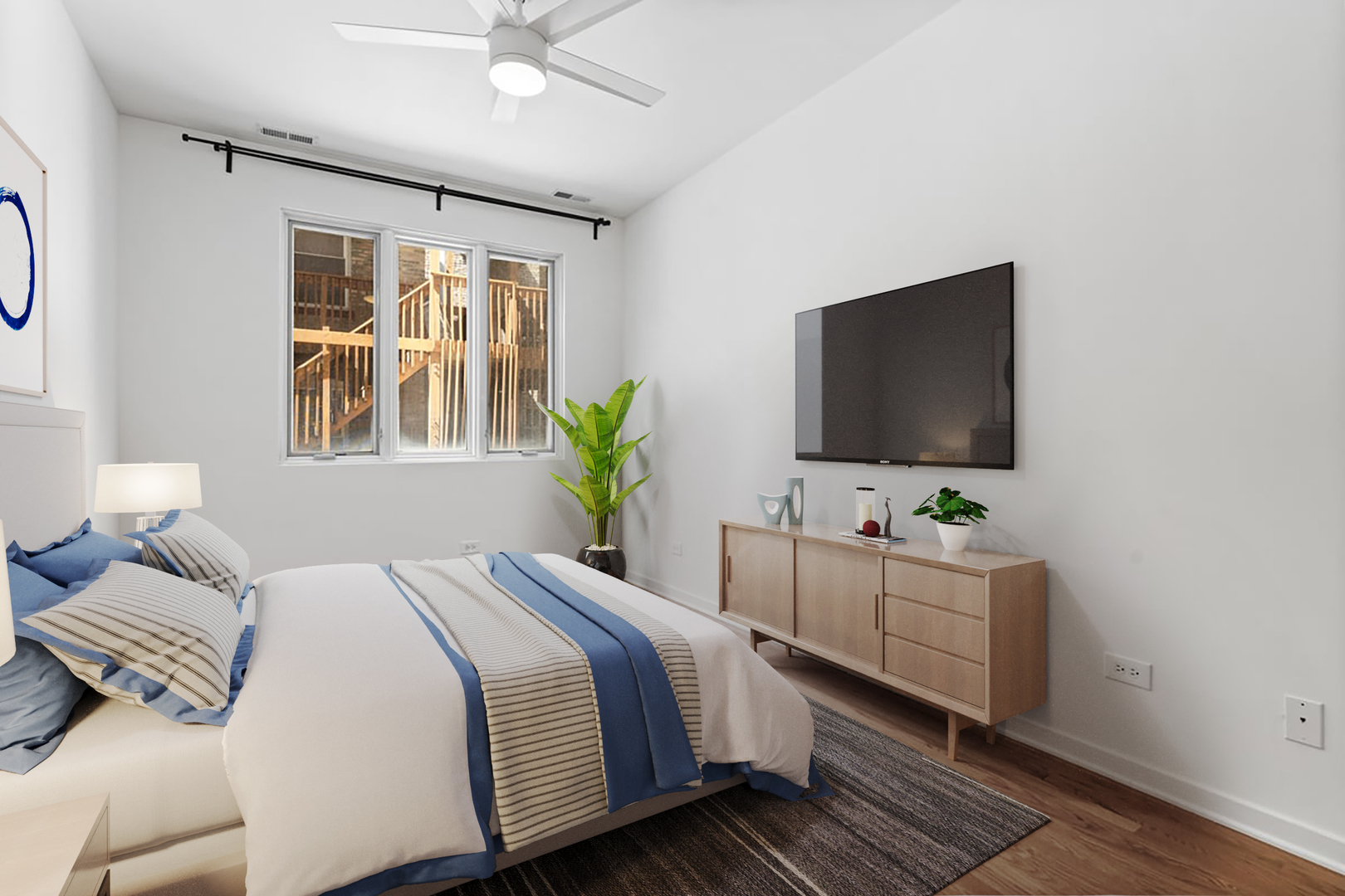 3021 West Armitage Avenue, Unit 208 Chicago, IL 60647 - Photo 11 of 18 a bedroom with a bed and a flat screen tv