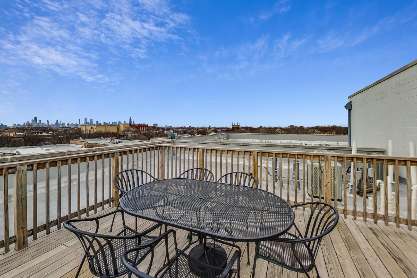3021 West Armitage Avenue, Unit 208 Chicago, IL 60647 - Photo 16 of 18 a view of a balcony with wooden floor and city view