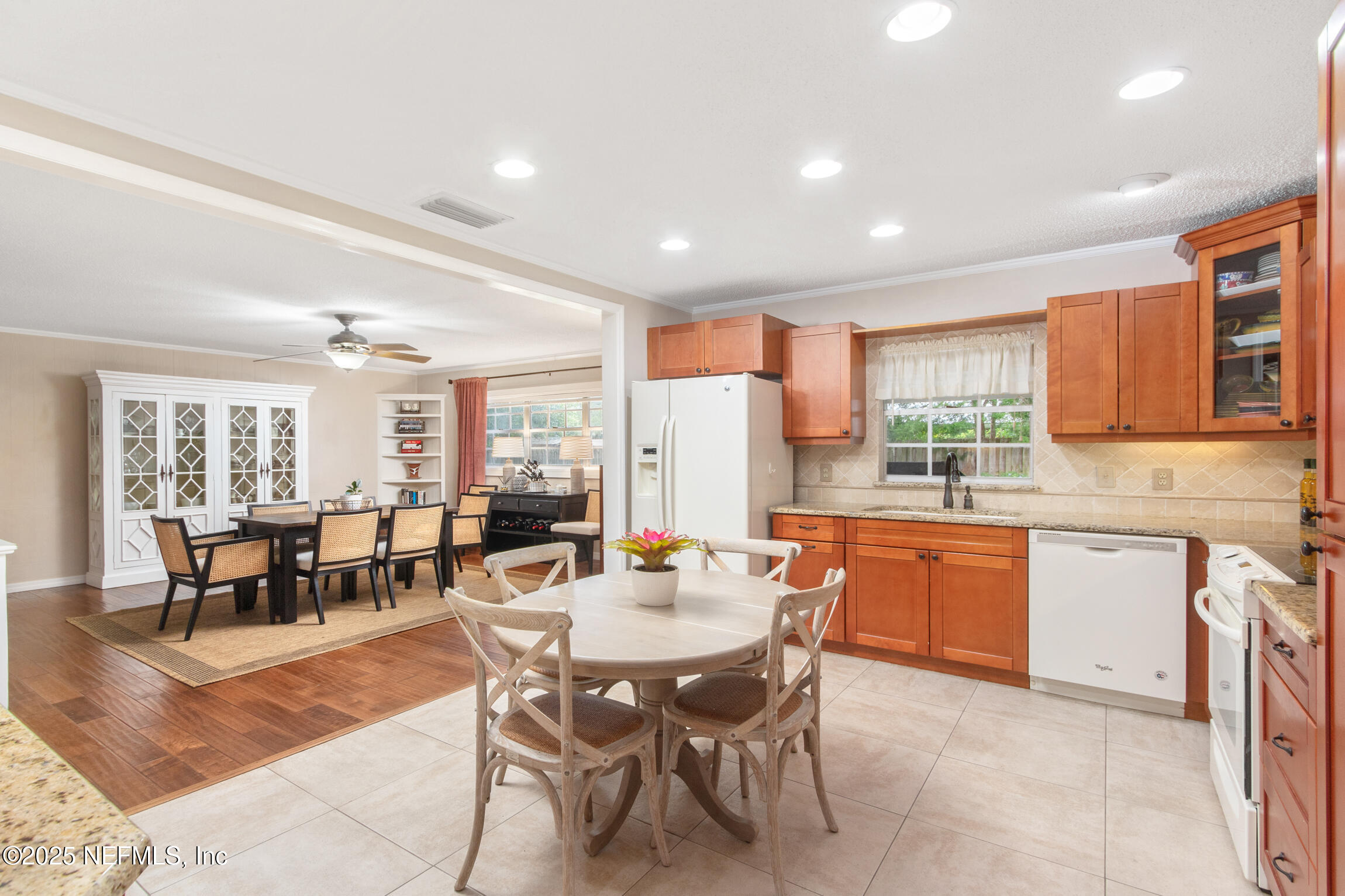 405 Lobelia Road St. Augustine, FL 32086 - Photo 13 of 40 a dining hall with stainless steel appliances granite countertop a stove a sink a dining table and chairs
