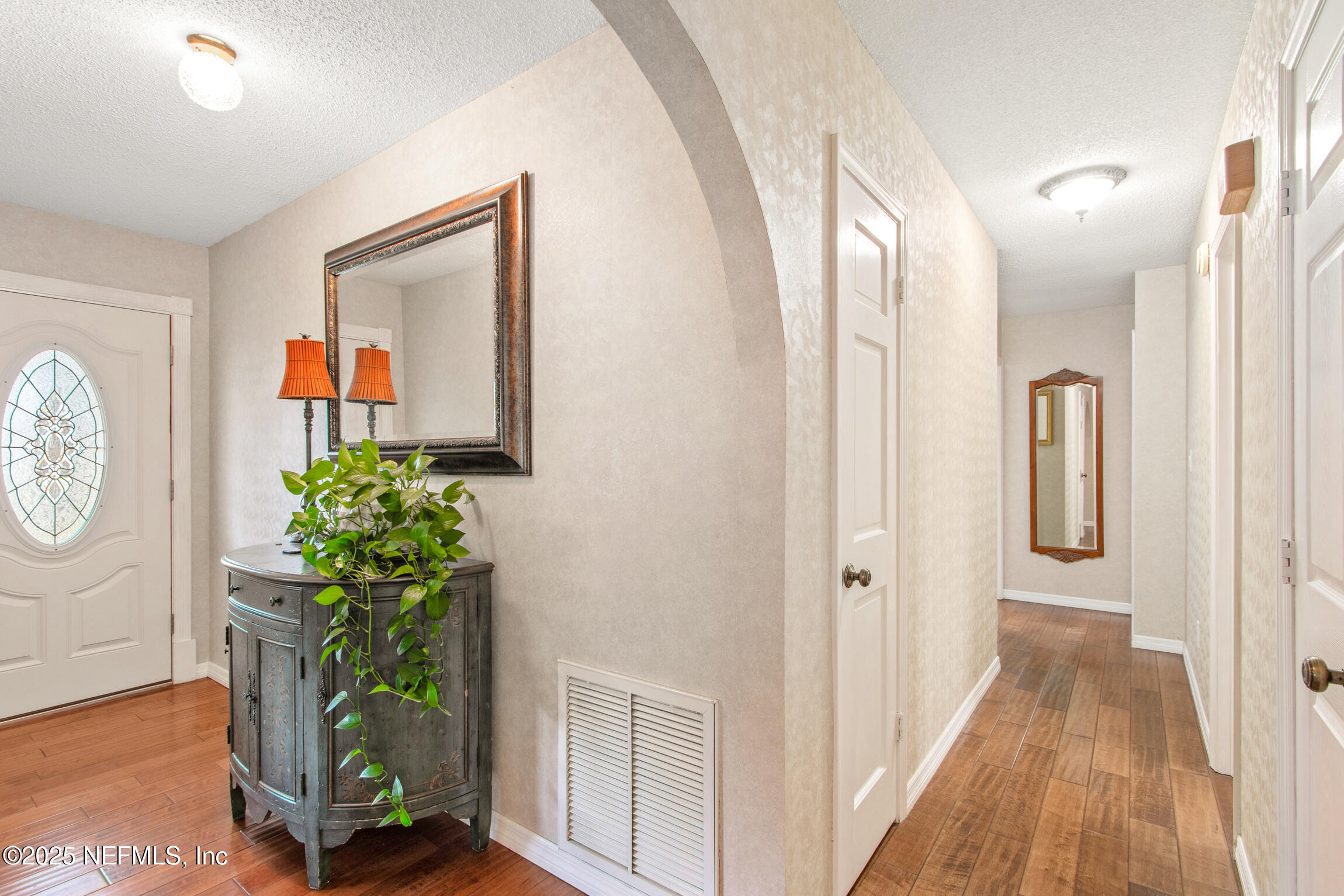 405 Lobelia Road St. Augustine, FL 32086 - Photo 17 of 40 a view of a hallway with paintings on the wall