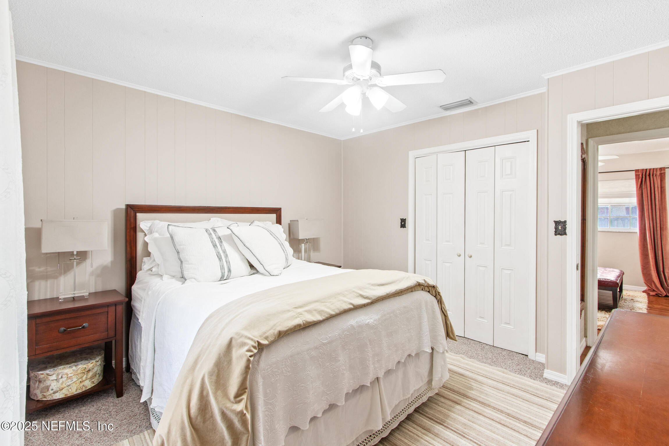 405 Lobelia Road St. Augustine, FL 32086 - Photo 18 of 40 a bedroom with a bed and a chandelier