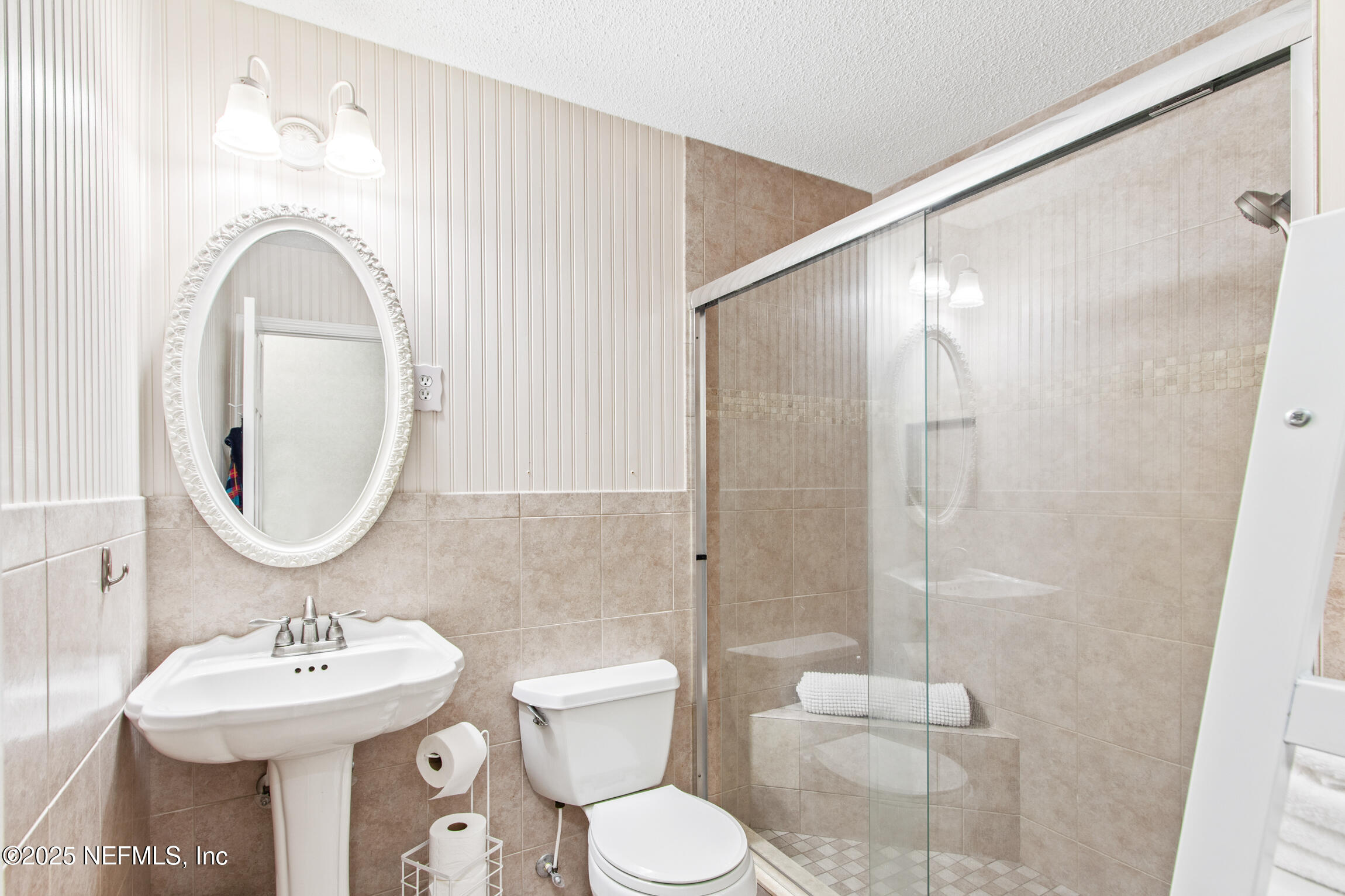 405 Lobelia Road St. Augustine, FL 32086 - Photo 20 of 40 a bathroom with a toilet sink shower and mirror