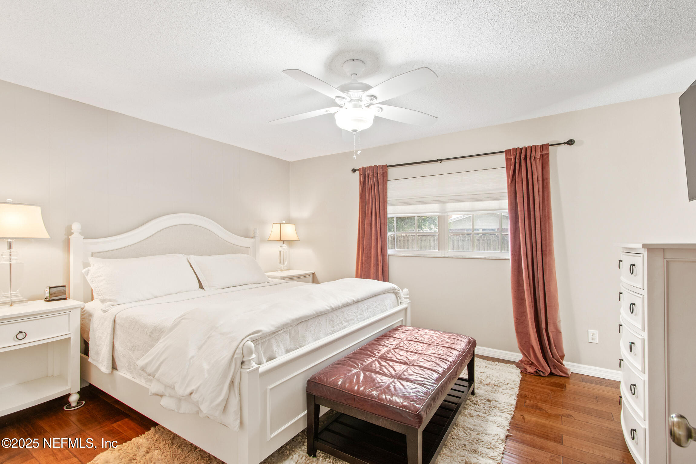 405 Lobelia Road St. Augustine, FL 32086 - Photo 21 of 40 a bedroom with a bed and a chandelier