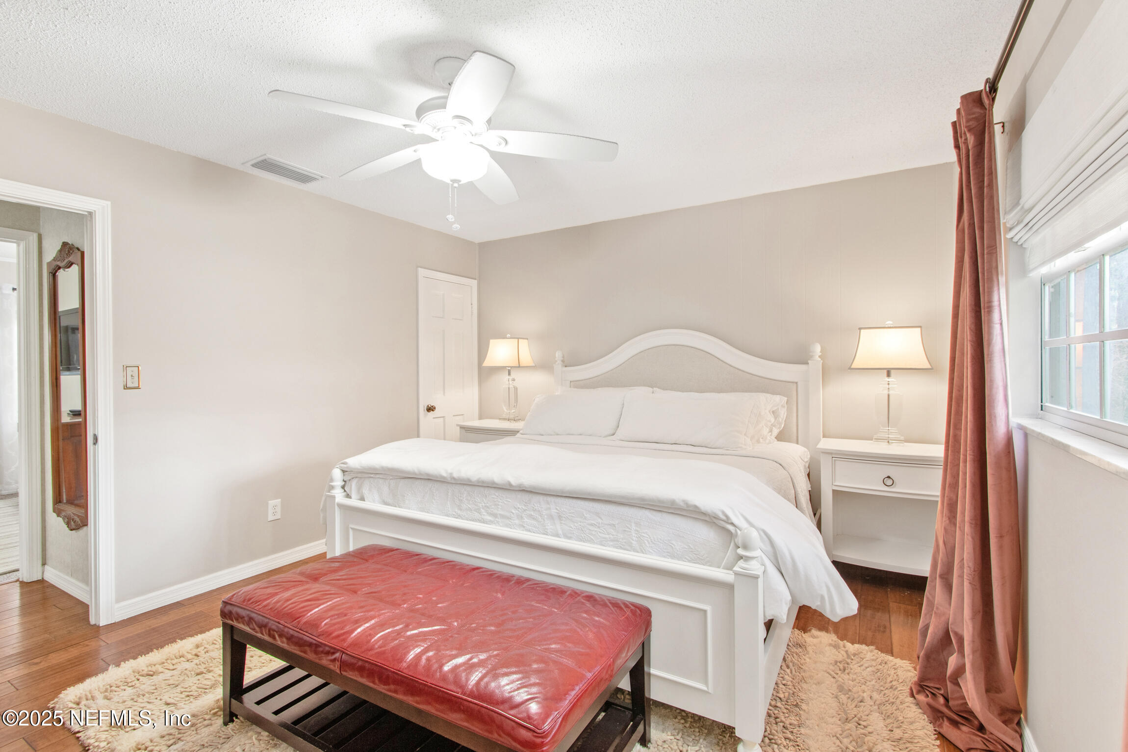 405 Lobelia Road St. Augustine, FL 32086 - Photo 22 of 40 a bedroom with a bed and a chandelier