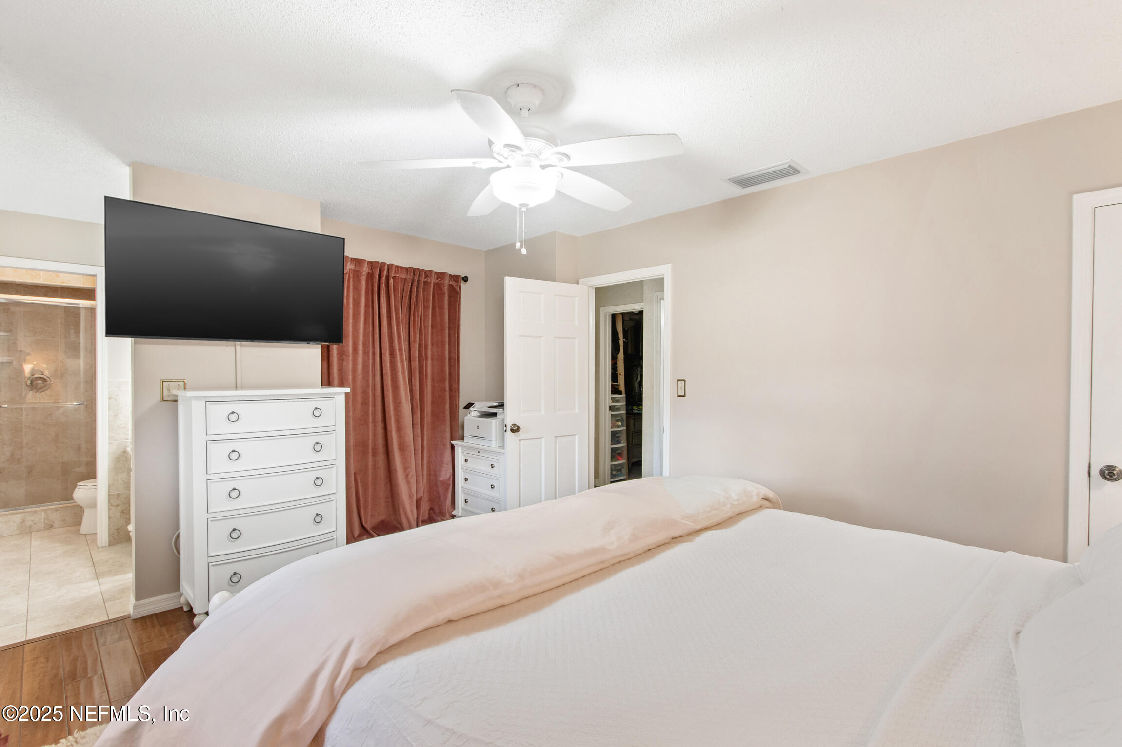 405 Lobelia Road St. Augustine, FL 32086 - Photo 23 of 40 a bedroom with a bed and a flat screen tv