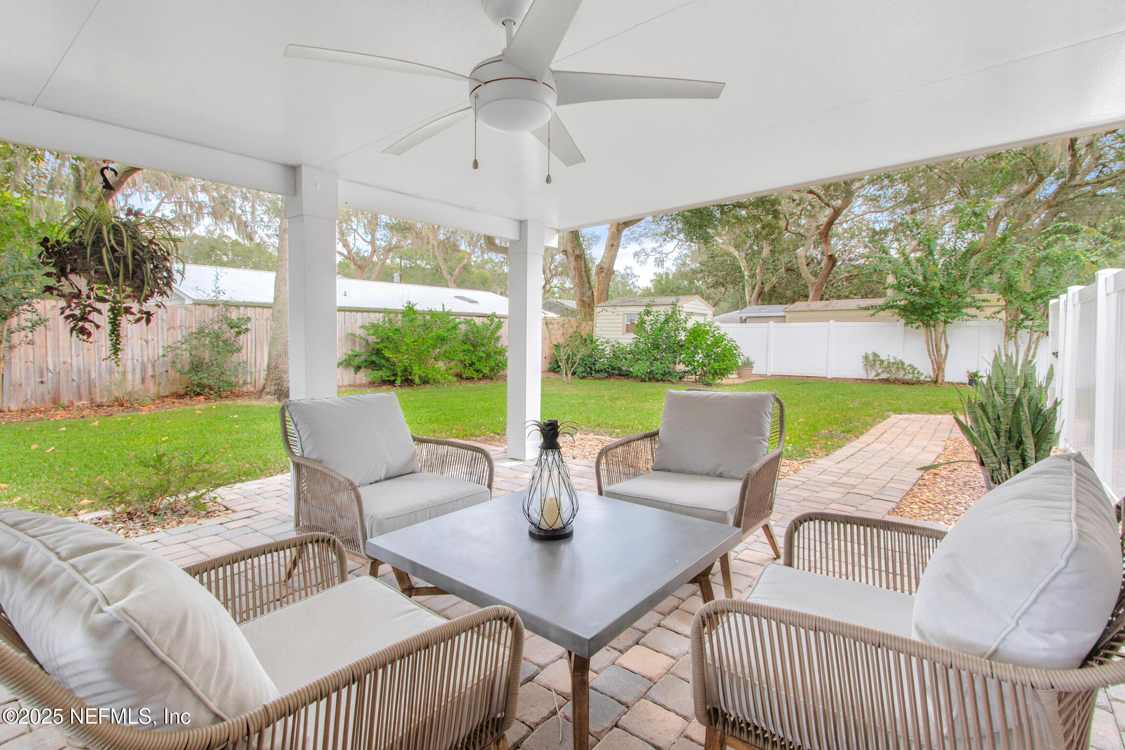 405 Lobelia Road St. Augustine, FL 32086 - Photo 27 of 40 a view of a patio with a table chairs and a yard