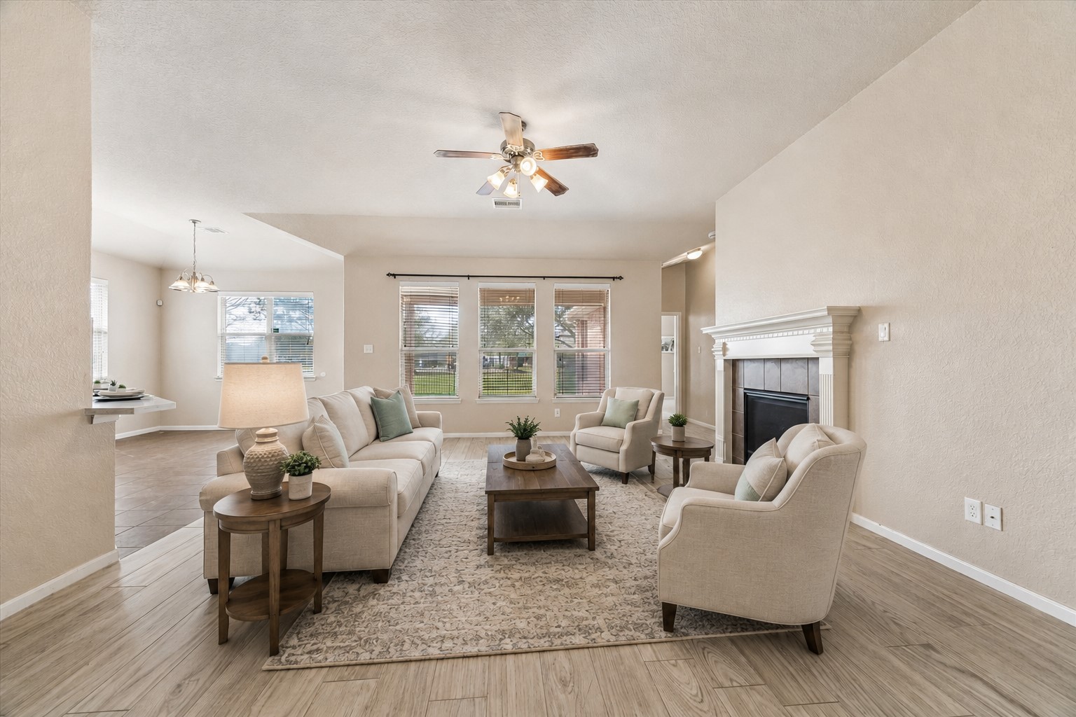 7806 Summer Night Lane Rosenberg, TX 77469 - Photo 3 of 23 The main living area features a wood-burning fireplace with a traditional mantel and a ceiling fan for air circulation. **This room has been virtually staged.