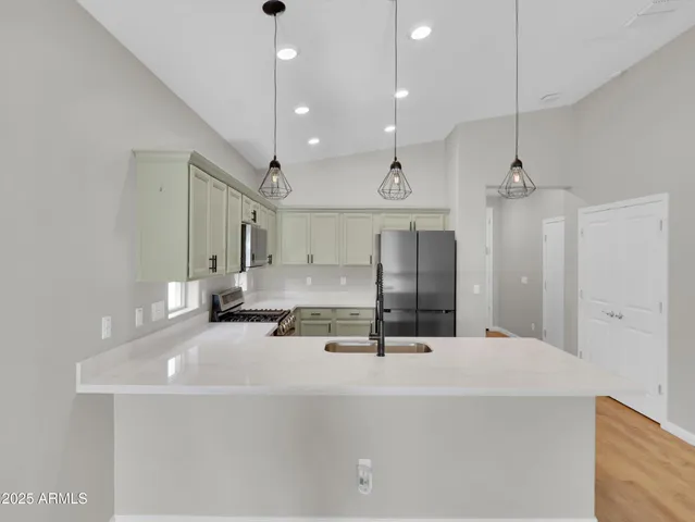 a kitchen with a refrigerator and a sink