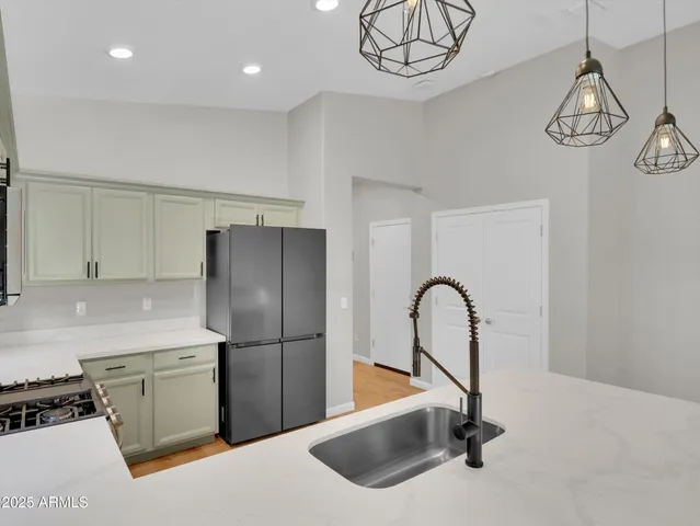 a kitchen with a sink and chandelier