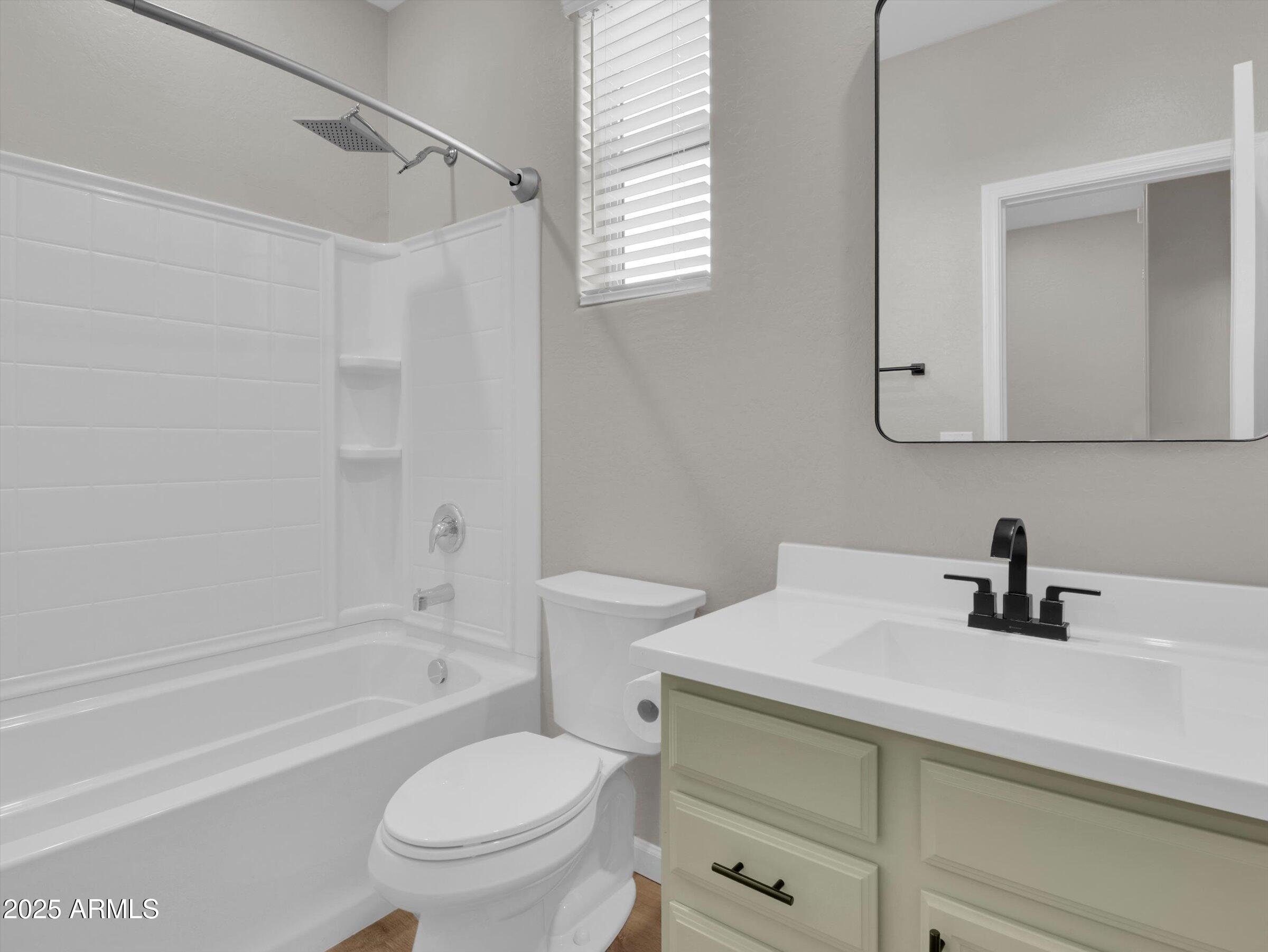3405 West Alta Vista Road Phoenix, AZ 85041 - Photo 18 of 40 a bathroom with a sink a toilet and a bathtub