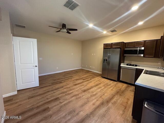 3405 West Alta Vista Road Phoenix, AZ 85041 - Photo 27 of 40 a view of a kitchen with a stove wooden floor and a refrigerator