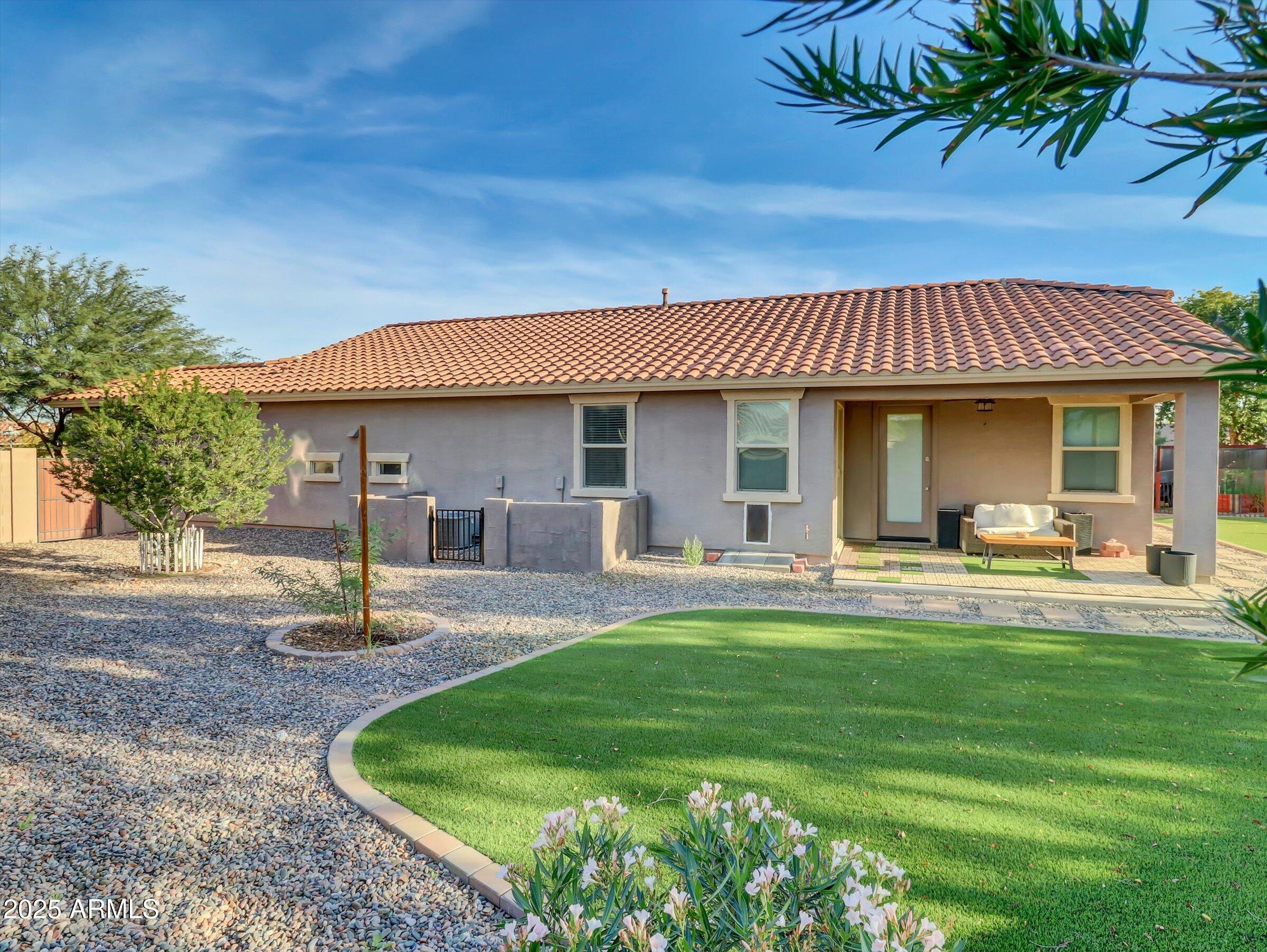 3405 West Alta Vista Road Phoenix, AZ 85041 - Photo 6 of 40 a front view of a house with swimming pool having outdoor seating