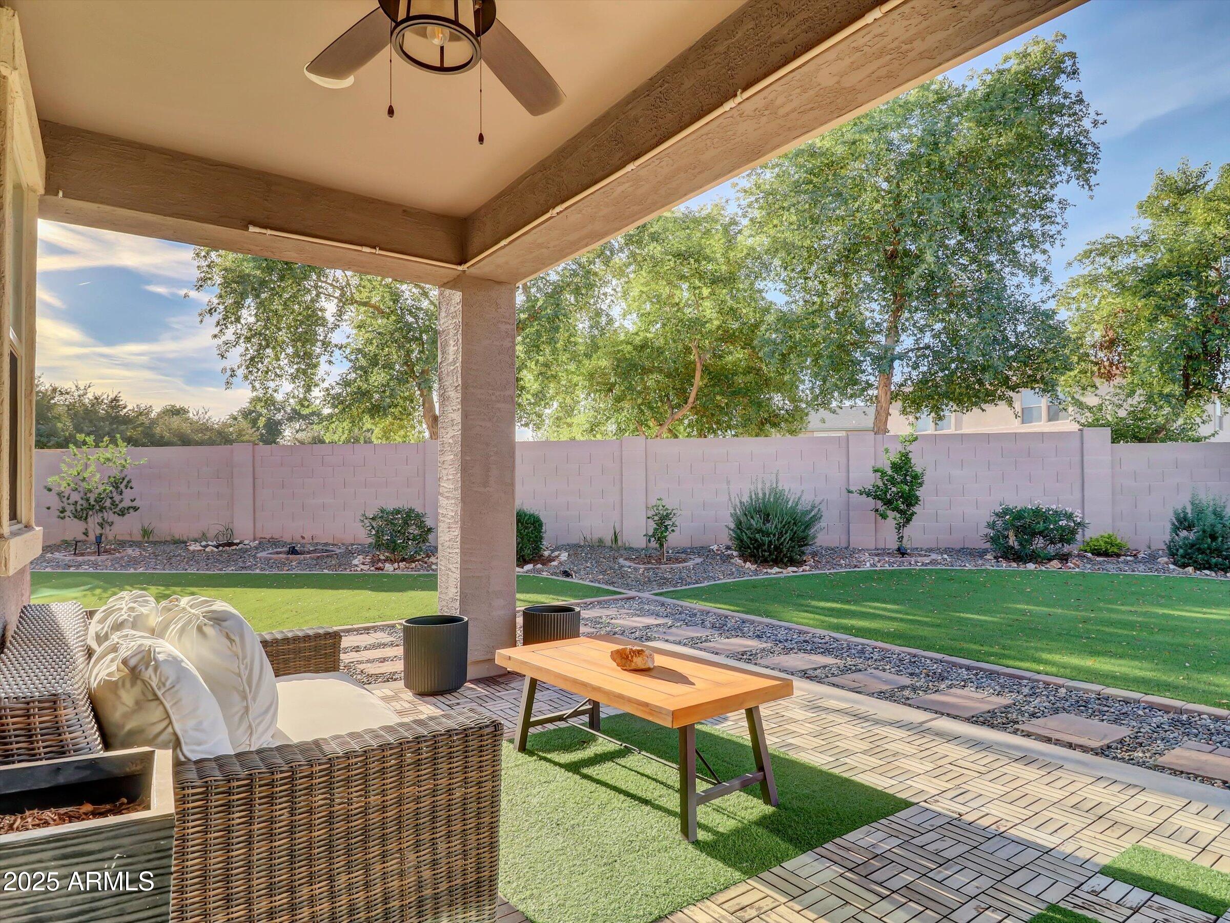 3405 West Alta Vista Road Phoenix, AZ 85041 - Photo 8 of 40 a view of a patio with table and chairs potted plants and a palm tree