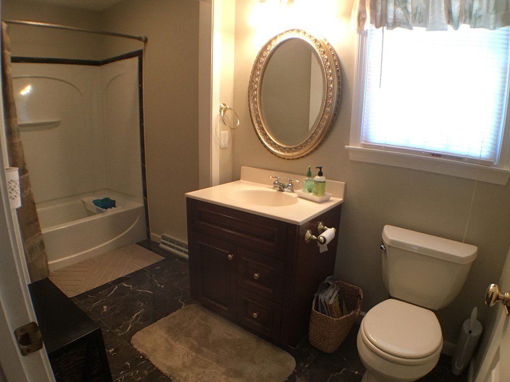 669 Shaker Road Longmeadow, MA 01106 - Photo 15 of 28 a bathroom with a toilet a sink a mirror and a bathtub