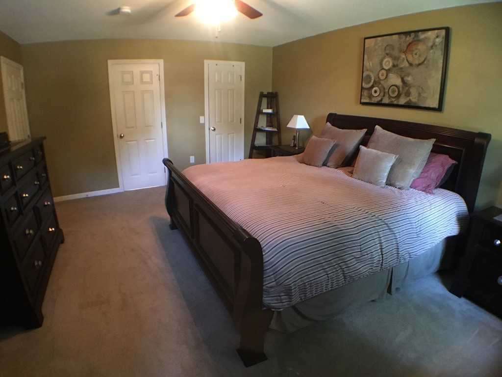 669 Shaker Road Longmeadow, MA 01106 - Photo 16 of 28 a spacious bedroom with a bed and painting on the wall