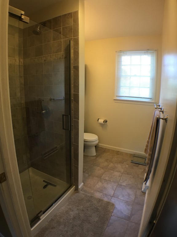 669 Shaker Road Longmeadow, MA 01106 - Photo 17 of 28 a bathroom with a shower and a toilet
