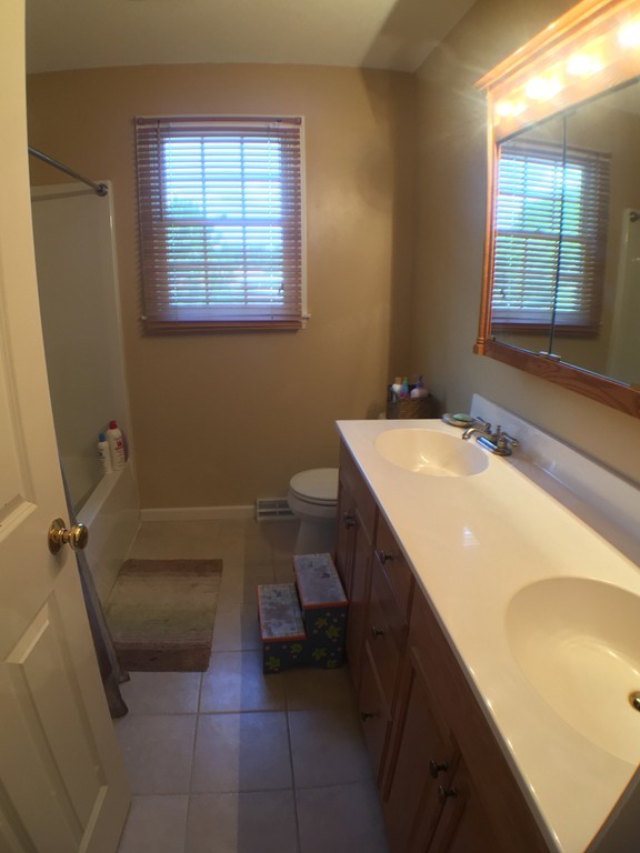 669 Shaker Road Longmeadow, MA 01106 - Photo 21 of 28 a bathroom with a sink a toilet and tub