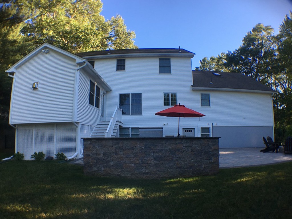 669 Shaker Road Longmeadow, MA 01106 - Photo 3 of 28 a front view of a house with a yard and garage
