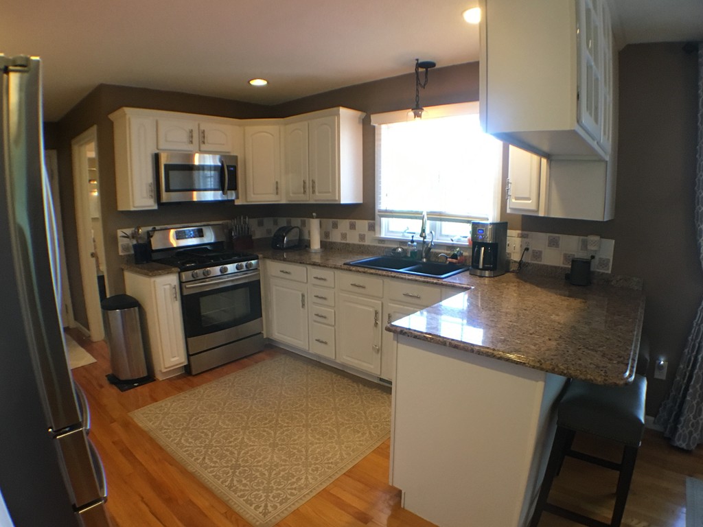 669 Shaker Road Longmeadow, MA 01106 - Photo 9 of 28 a kitchen with stainless steel appliances granite countertop sink stove top oven and cabinets