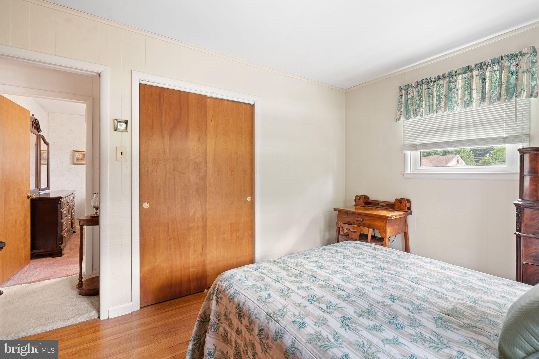 604 Davis Road Barrington, NJ 08007 - Photo 12 of 30 a bedroom with a bed and wooden floor