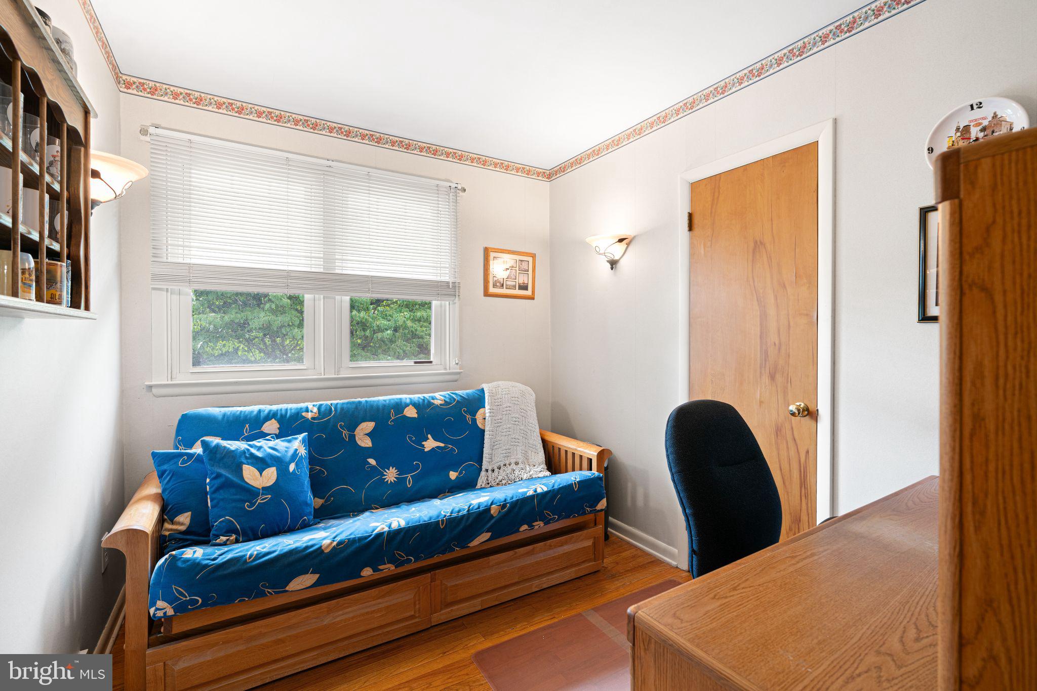 604 Davis Road Barrington, NJ 08007 - Photo 13 of 30 a blue couch sitting in a living room next to a window