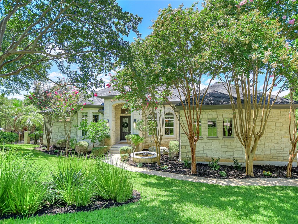 a view of backyard of house with green space