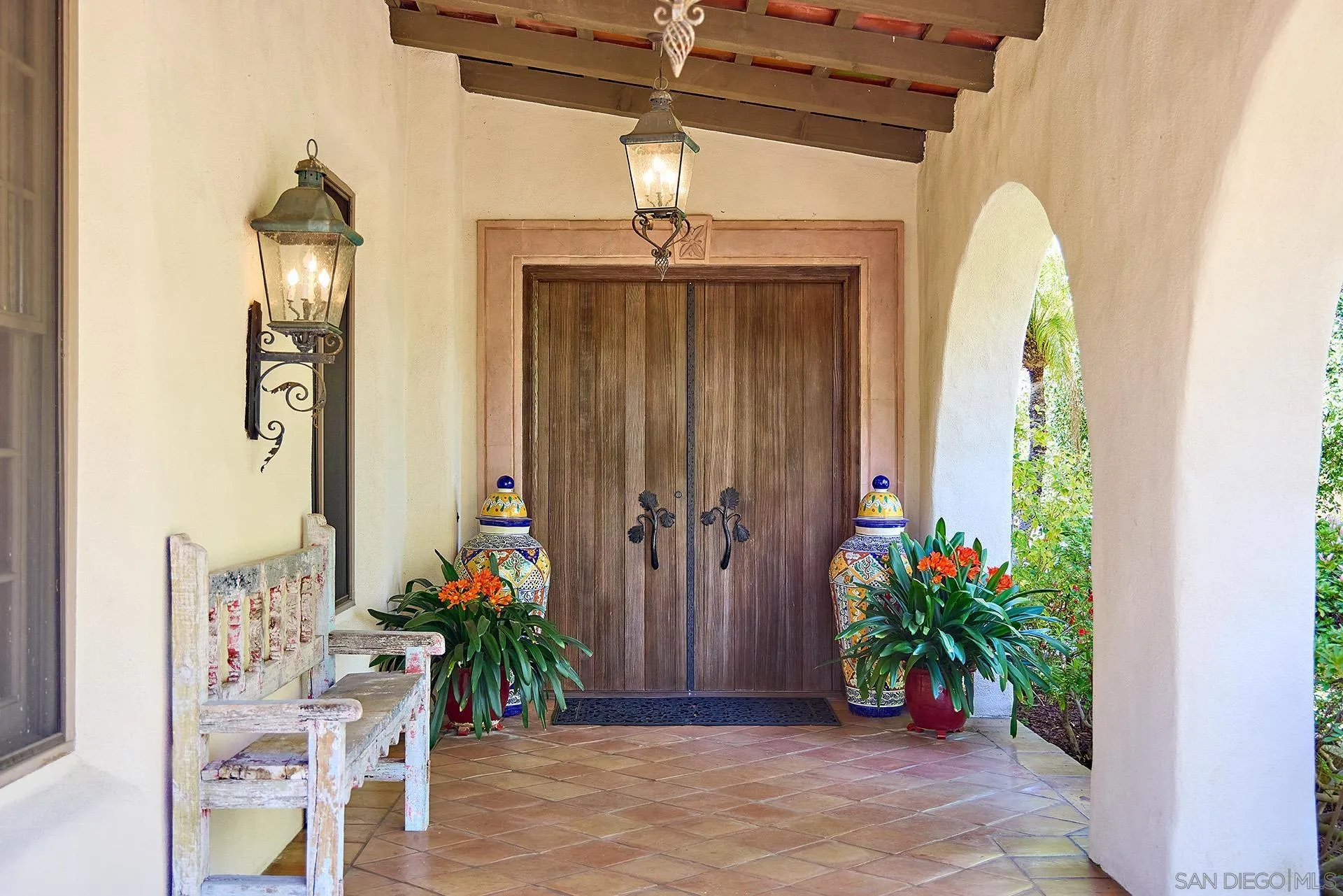 6525 Lago Lindo Rancho Santa Fe, CA 92067 - Photo 12 of 47 Beautiful custom front doors with detailed hardware. Ivory stucco exterior, red clay tile roof, Moorish chimneys