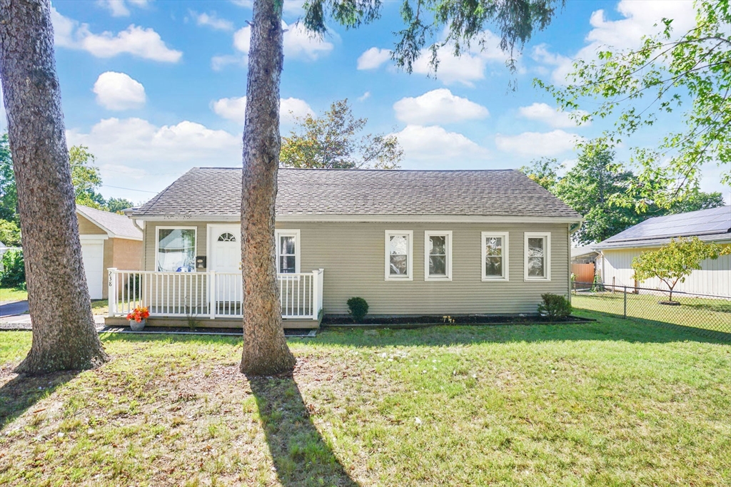 a front view of a house with a garden and yard