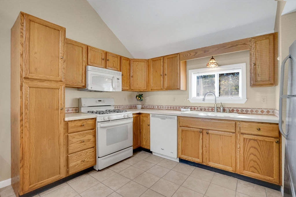 238 Merrimac Avenue Springfield, MA 01104 - Photo 17 of 37 a kitchen with granite countertop white cabinets sink and stainless steel appliances