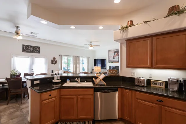 a living room with furniture and a view of kitchen