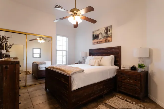 a bedroom with a bed and a chandelier