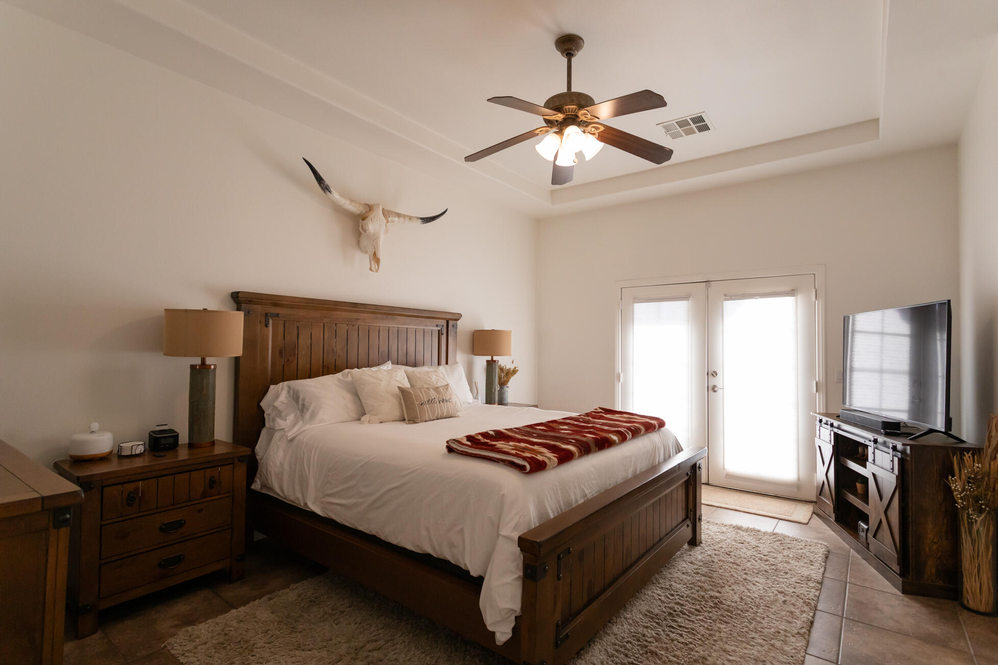 48305 Pic Way Indio, CA 92201 - Photo 49 of 80 a bedroom with a bed and a chandelier