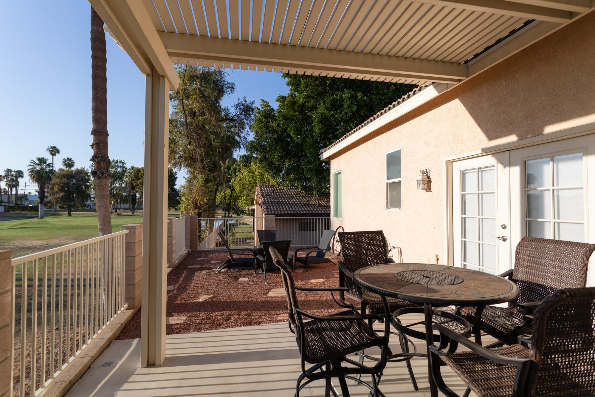 48305 Pic Way Indio, CA 92201 - Photo 58 of 80 a view of a patio with table and chairs with wooden floor and fence