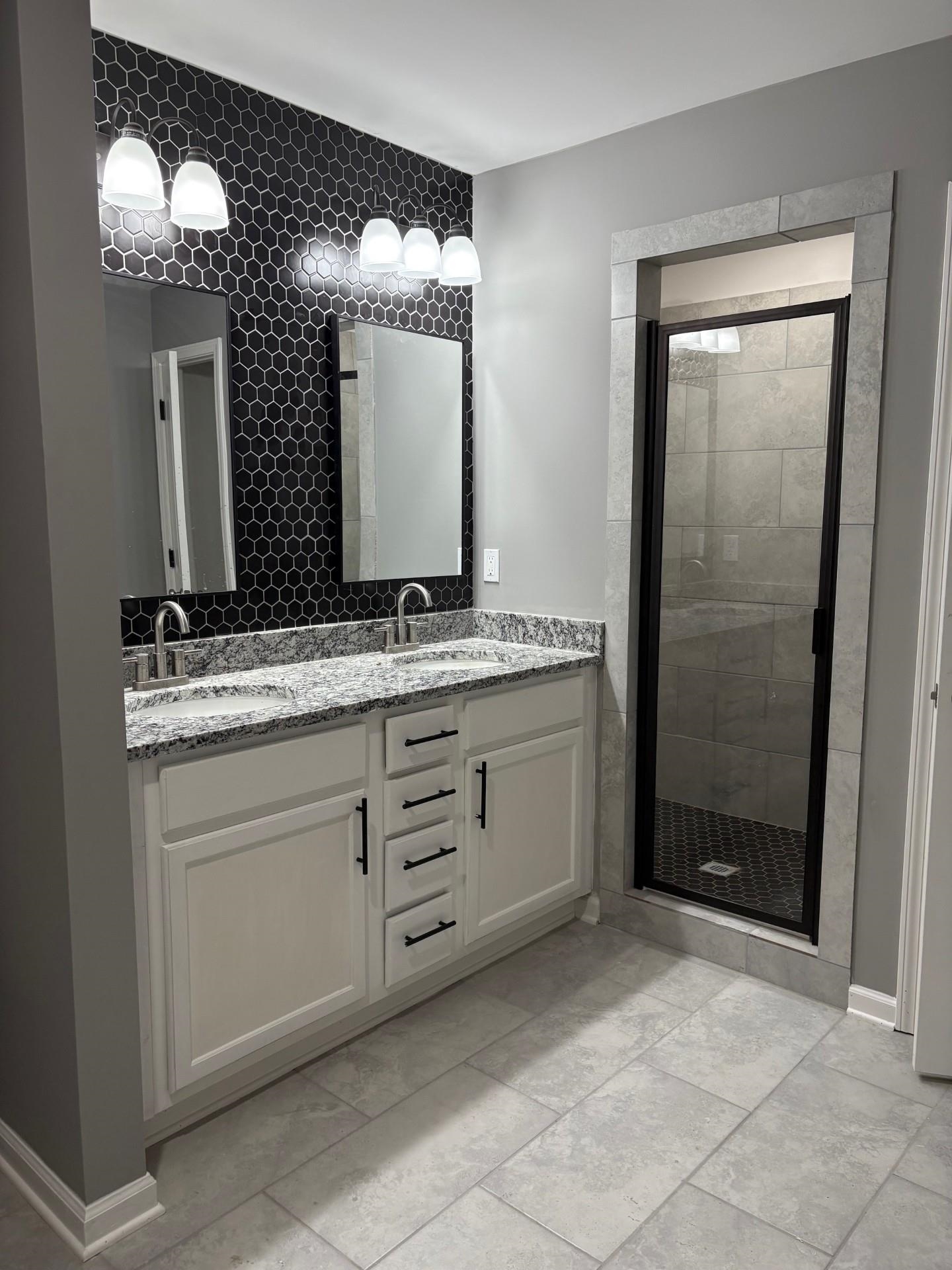 3723 Whittier Road Memphis, TN 38108 - Photo 11 of 11 a bathroom with a sink and a mirror