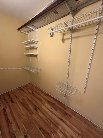 a view of a room with wooden floor