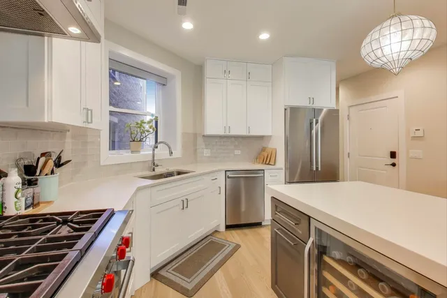 a kitchen with a sink appliances and cabinets