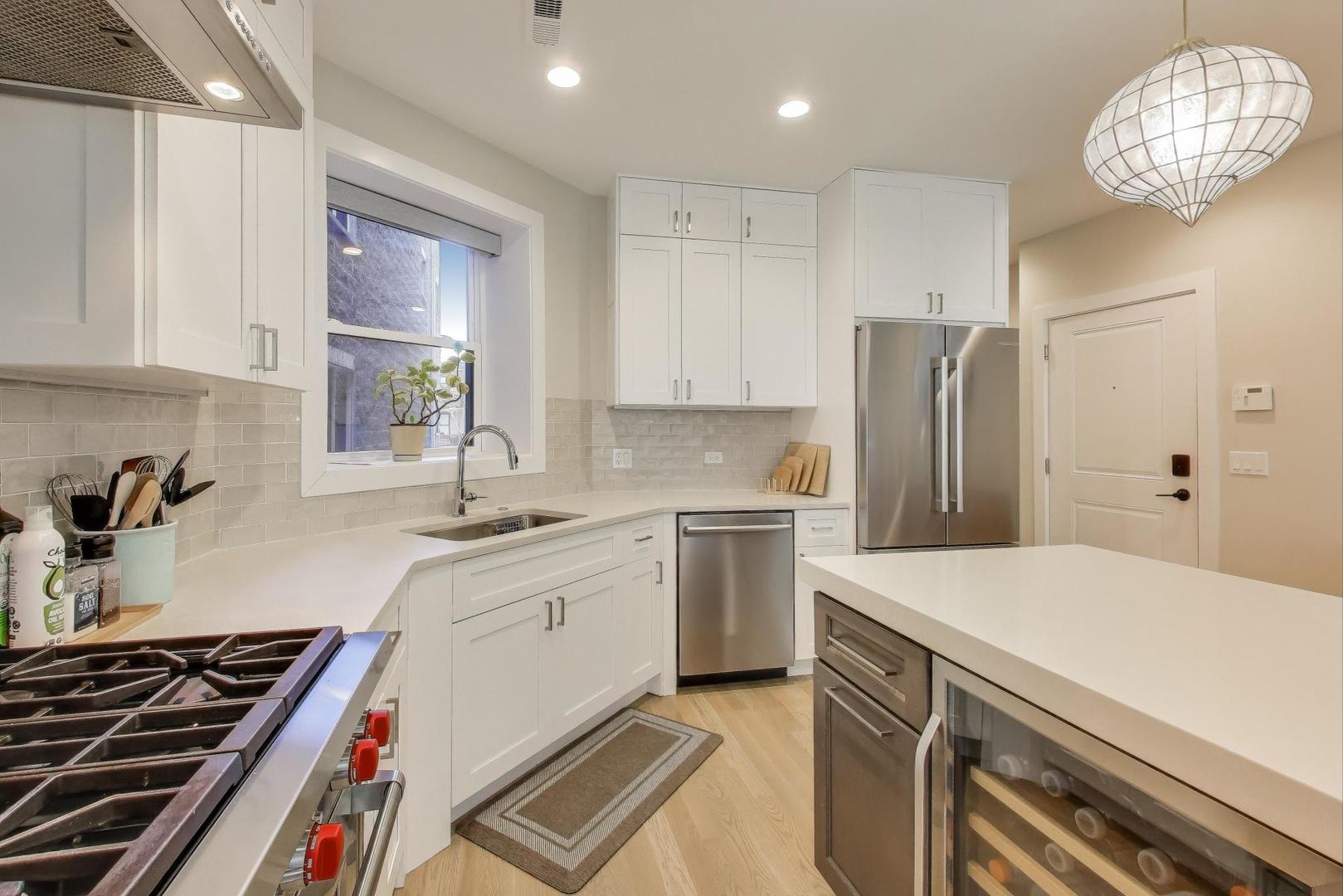 3533 North Fremont Street, Unit 2 Chicago, IL 60657 - Photo 11 of 30 a kitchen with a sink appliances and cabinets